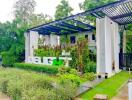 Lush greenery surrounding a modern building facade with a 'DELIGHT' sign