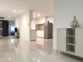 Modern open plan living room with kitchen and shiny tiled flooring