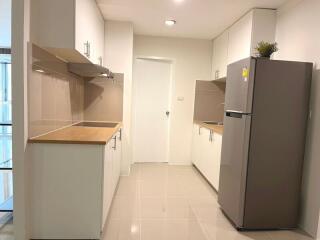 Modern kitchen interior with white tiles and appliances