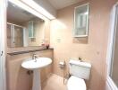 Spacious bathroom with tan tiles and modern fixtures