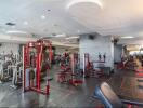 Modern gym with various exercise machines and equipment