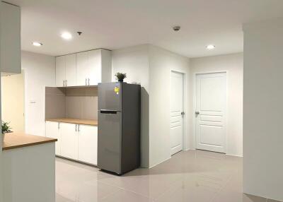 Modern kitchen interior with white cabinetry and tiled flooring