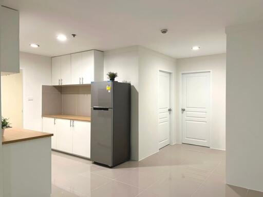 Modern kitchen interior with white cabinetry and tiled flooring