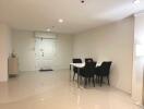 Modern dining area with table, chairs, and sleek tile flooring