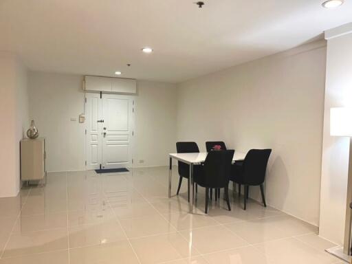 Modern dining area with table, chairs, and sleek tile flooring