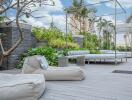 Modern outdoor lounge space with comfortable seating and lush greenery