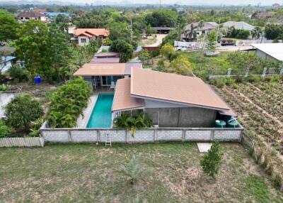 Aerial view of a residential property with swimming pool and garden