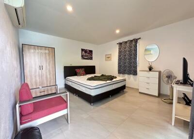 Spacious and well-lit bedroom with modern amenities