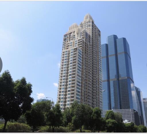 Exterior view of a modern high-rise residential building with blue sky in the background