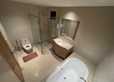 Spacious modern bathroom with a bathtub, shower, and bidet