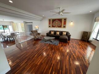 Spacious living room with polished hardwood floors and elegant decor