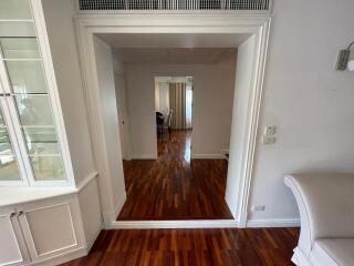 Bright and spacious hallway in a residential home with hardwood floors