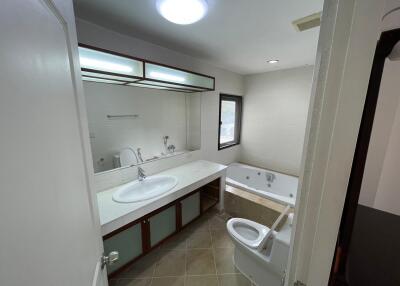 Spacious modern bathroom with double vanity and large mirror