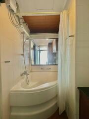 Bright bathroom with tub, shower, and wooden ceiling