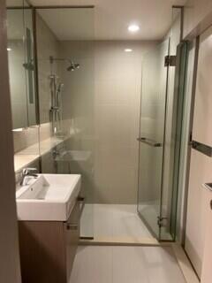 Modern bathroom with glass shower enclosure and vanity sink