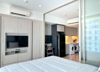 Modern bedroom with built-in appliances and workspace