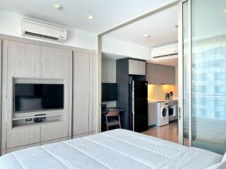 Modern bedroom with built-in appliances and workspace