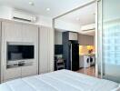 Modern bedroom with built-in appliances and workspace