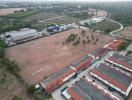 Aerial view of expansive open land near residential area suitable for development