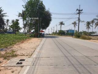 Empty roadside land with clear skies and a concrete road