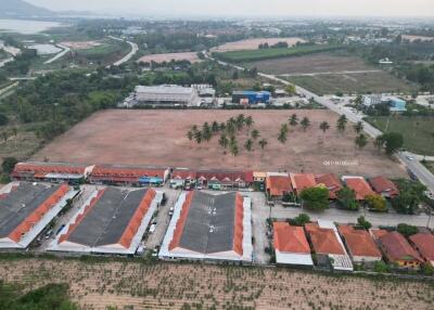 Aerial view of a residential development with surrounding open land