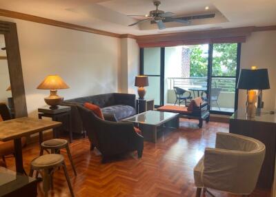 Spacious living room with furniture and balcony access