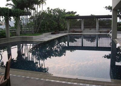 Private outdoor swimming pool with surrounding relaxation area