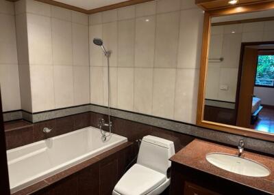 Modern bathroom with bathtub, shower, toilet, and sink