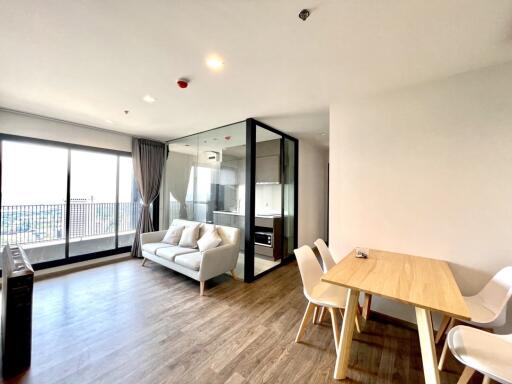 Spacious and well-lit living room with open dining area