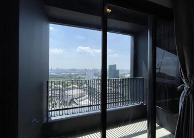 Bright bedroom with a city view and balcony access