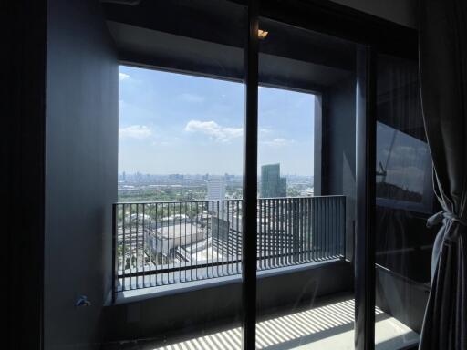 Bright bedroom with a city view and balcony access