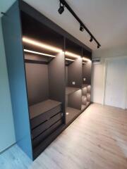 Modern bedroom with built-in wardrobe and track lighting