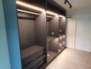 Modern bedroom with built-in wardrobe and track lighting