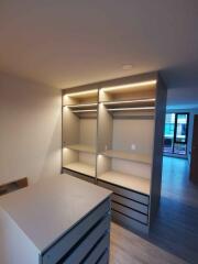 Modern bedroom interior with built-in wardrobe and LED lighting