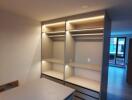 Modern bedroom interior with built-in wardrobe and LED lighting