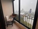 Cozy corner in a high-rise building with a large window showing city views on a rainy day