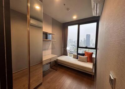 Compact bedroom with large window and city view