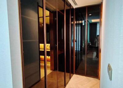 Elegant corridor with glass-panelled sliding doors leading to rooms