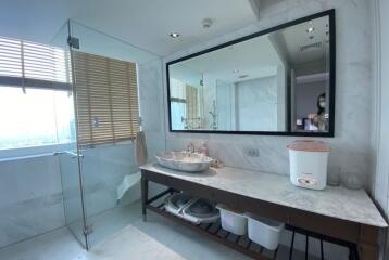 Modern bathroom interior with a large mirror and natural light