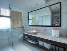 Modern bathroom interior with a large mirror and natural light