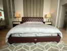 Elegant bedroom with a large tufted bed and stylish decor