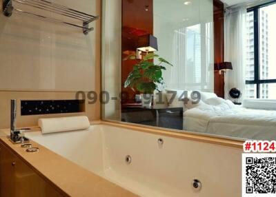 Modern bathroom with bathtub and view to the bedroom