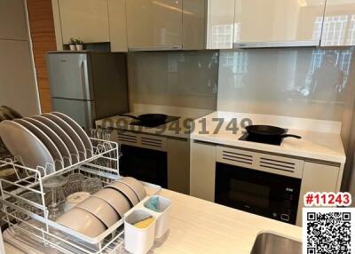 Modern kitchen with stainless steel appliances and white cabinetry