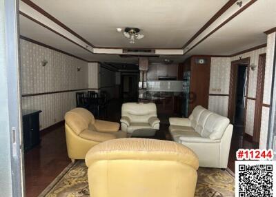 Spacious living room with leather sofas and wooden accents