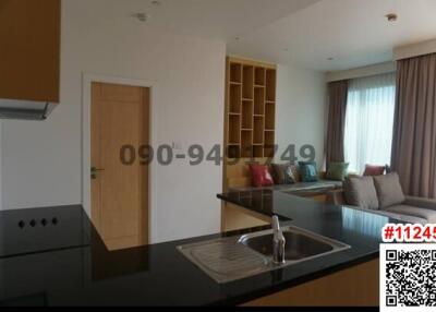 Modern living room and kitchen area with natural light