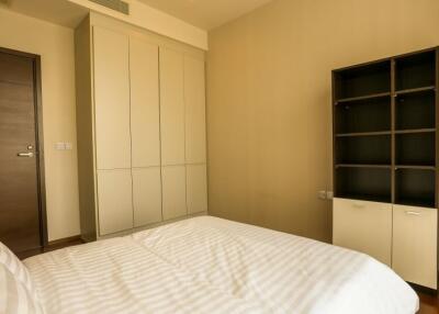 Modern bedroom with large bed and built-in wardrobes
