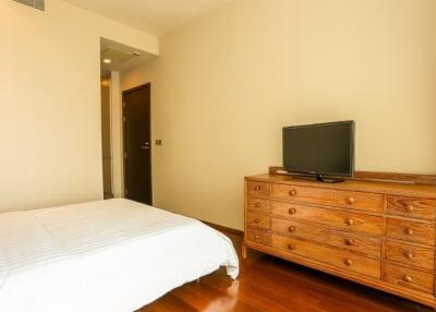Cozy bedroom with wooden furniture and hardwood floor