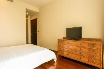 Cozy bedroom with wooden furniture and hardwood floor