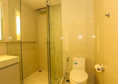 Modern bathroom with shower cubicle and beige tiles