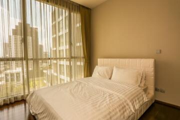 Modern bedroom with large window and city view